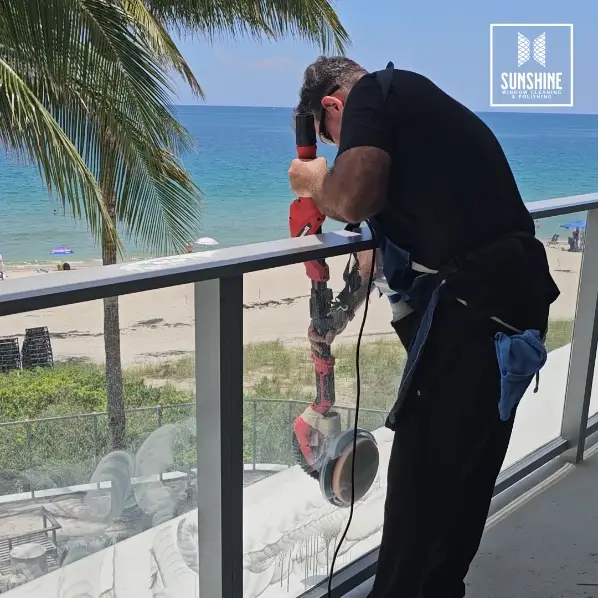 Man Polishing a Glass Panel